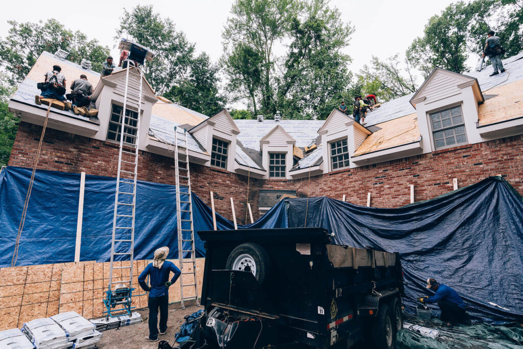 Origin Roofing & Exteriors team performing quality control checks during installation