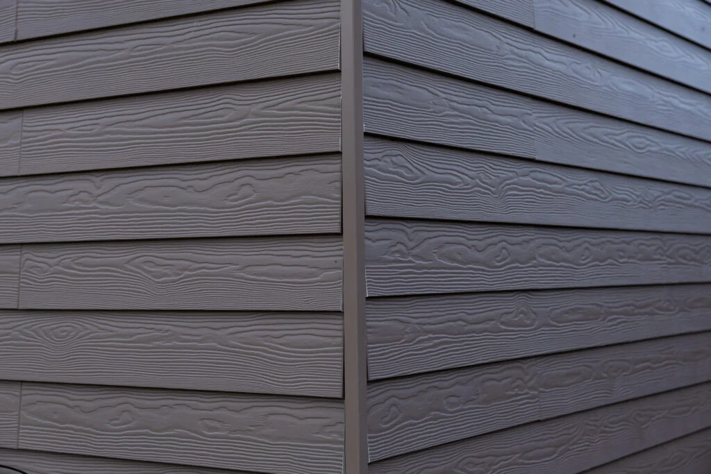 Close-up of newly installed vinyl siding with modern texture and color
