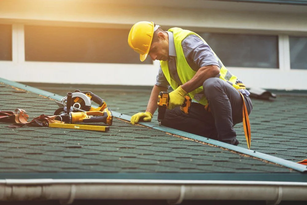 The Importance of Hiring Local Roofing Contractors in Louisville, KY 1 Roofer working on a steep asphalt roof under sunny Kentucky skies