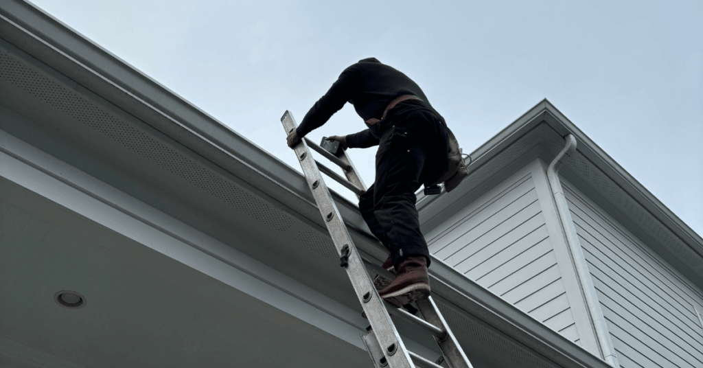 Roofer climbing a ladder to inspect storm damage immediately after a Louisville thunderstorm